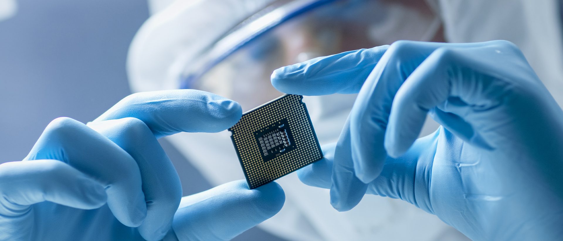 Laird header image man in safety gear examining microchip