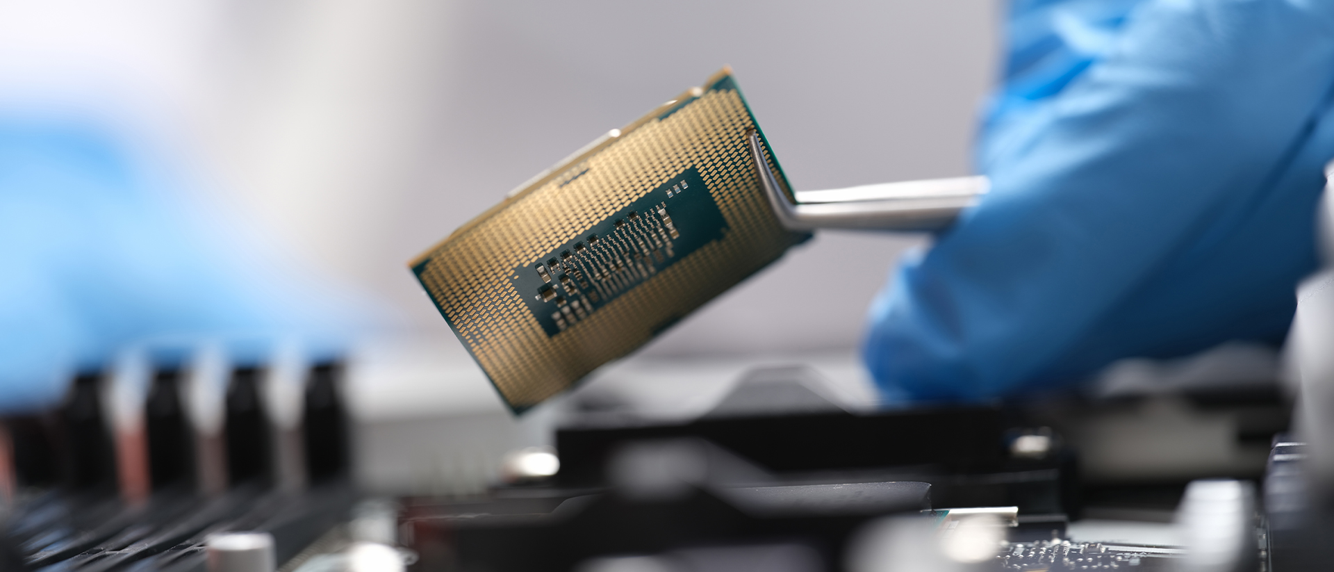 Laird header image microchip being held in tweezers