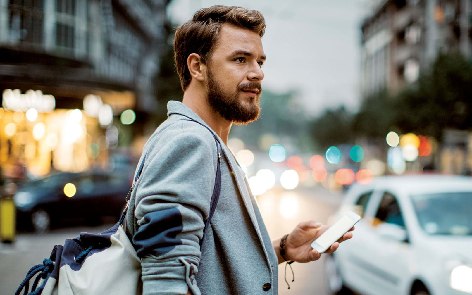 ePassi landscape image man checking phone in traffic