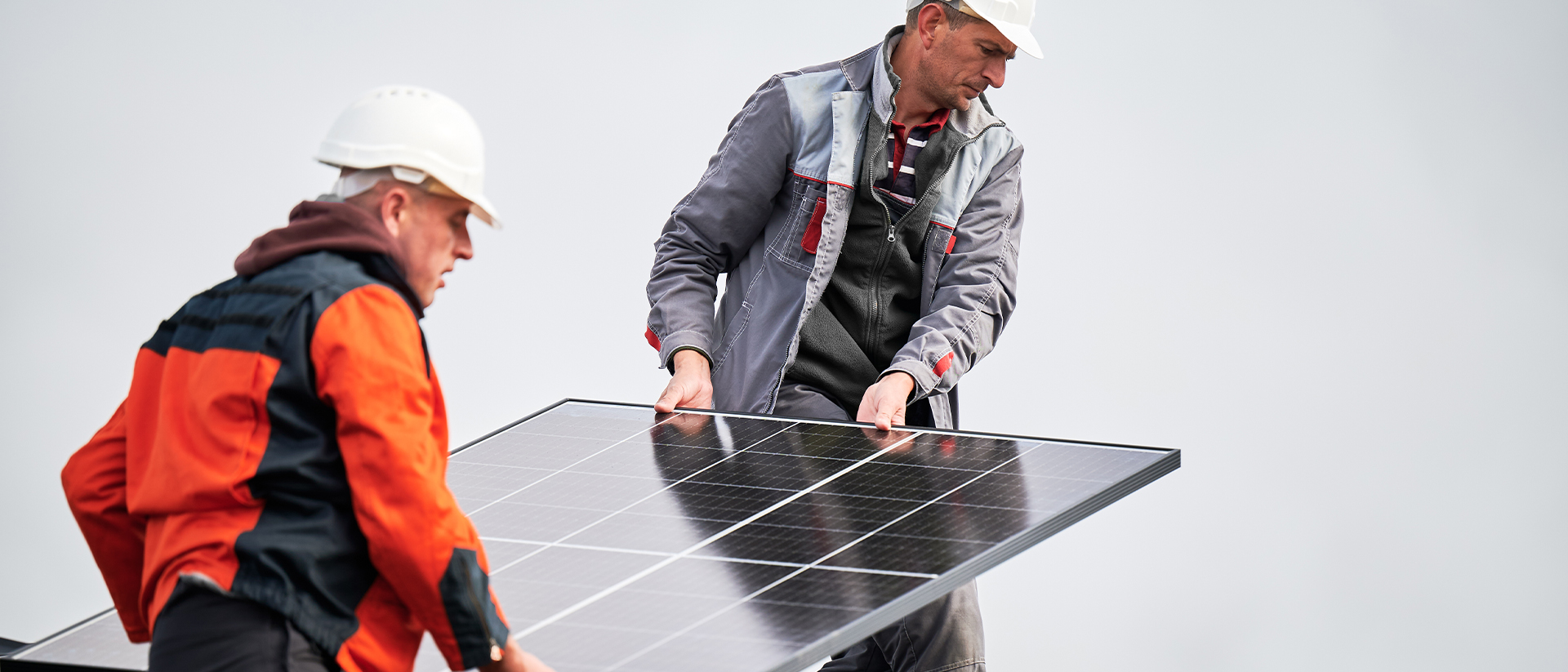 Solo Header 3 Two men carrying a solar panel