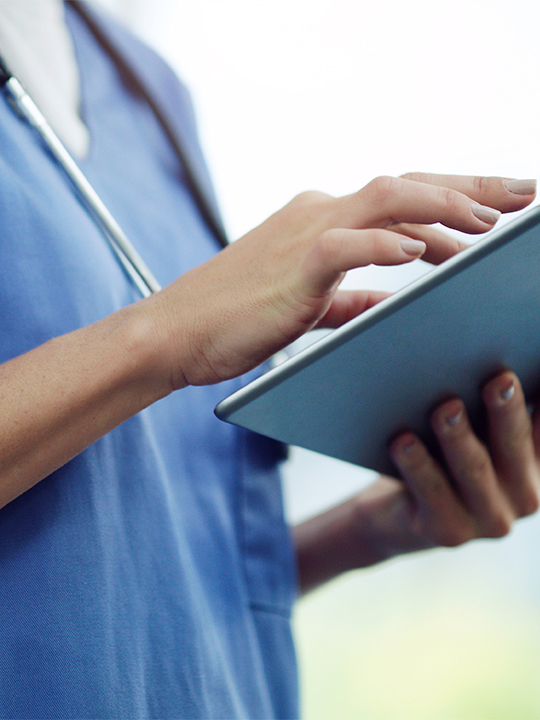 Finthrive Portrait 2 Nurse looking at tablet