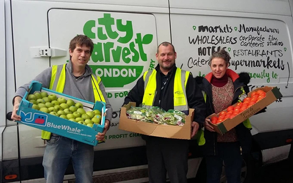 volunteers holding trays of food