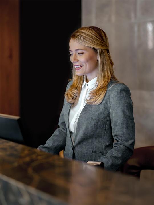 Single Digits Portrait 2 woman working at front desk