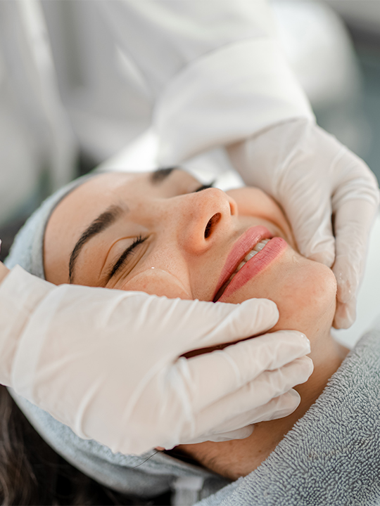 Integrated Dermatology Portrait 1 woman smiling getting a facial