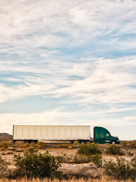 Transflo Portrait 2 truck driving through desert landscape