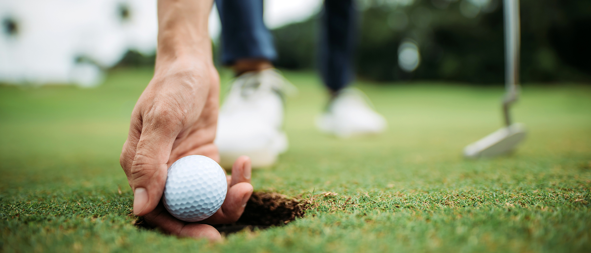 Perfect Drive Header 2 Hand picking up golf ball