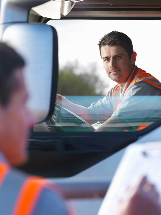 Seko Portrait 1 man in high vis looking out of window