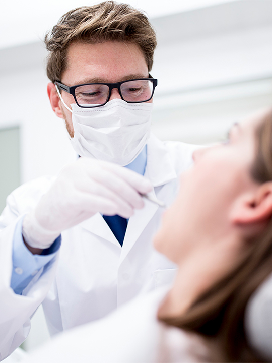 Dentalxchange Portrait 1 Dentist looking at patient's mouth