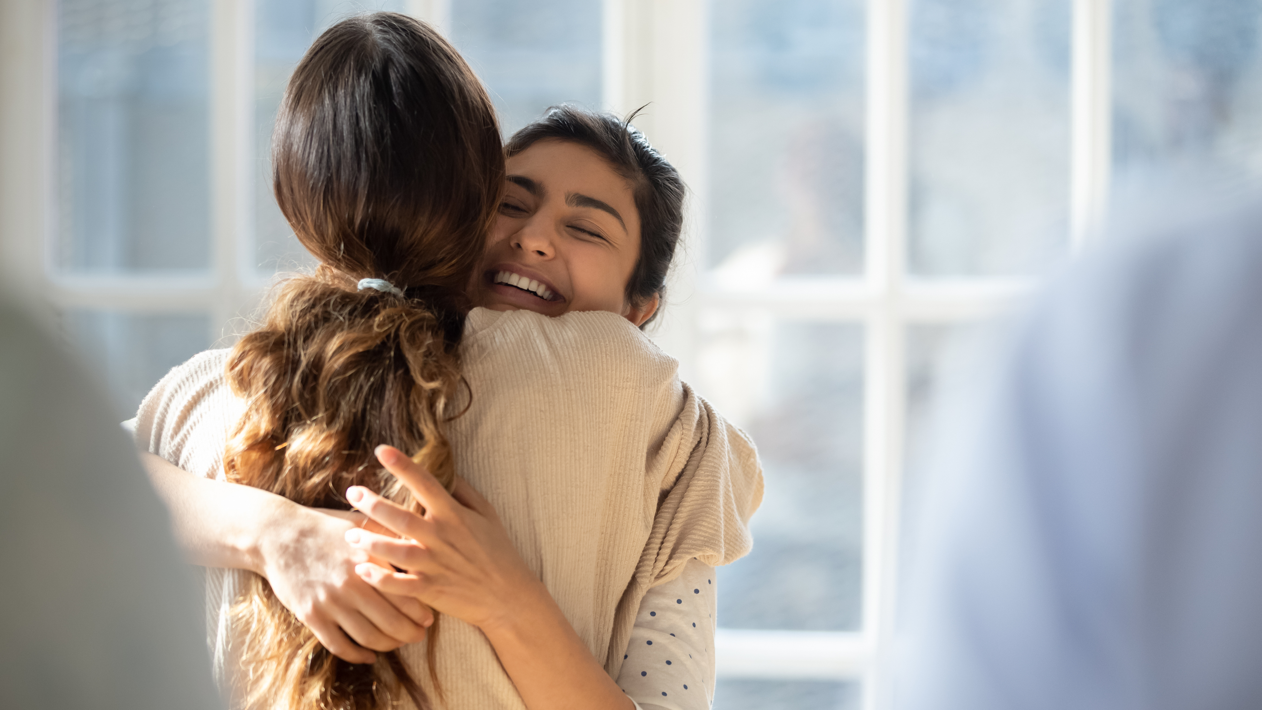 Corcentric two women hugging